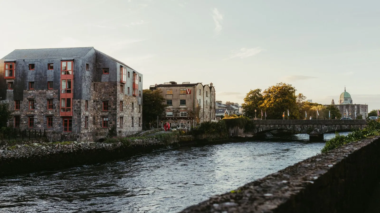 New apartment blocks beside the River Corrib in Galway city at sunset