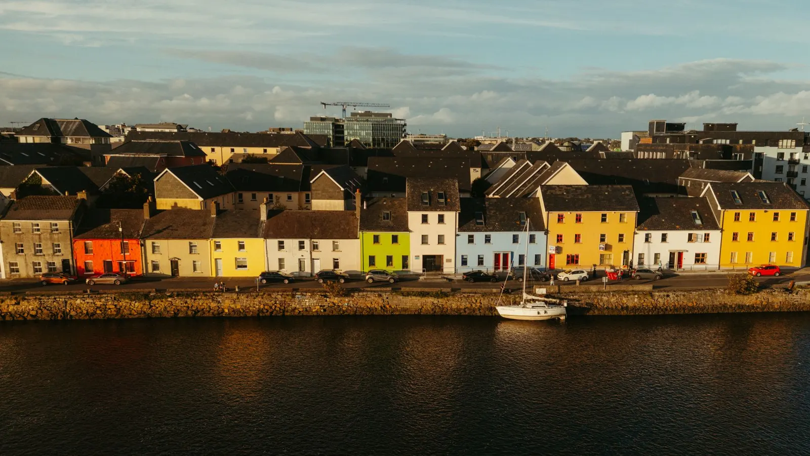 The colourful houses of the Long Walk in Galway seen across the harbour