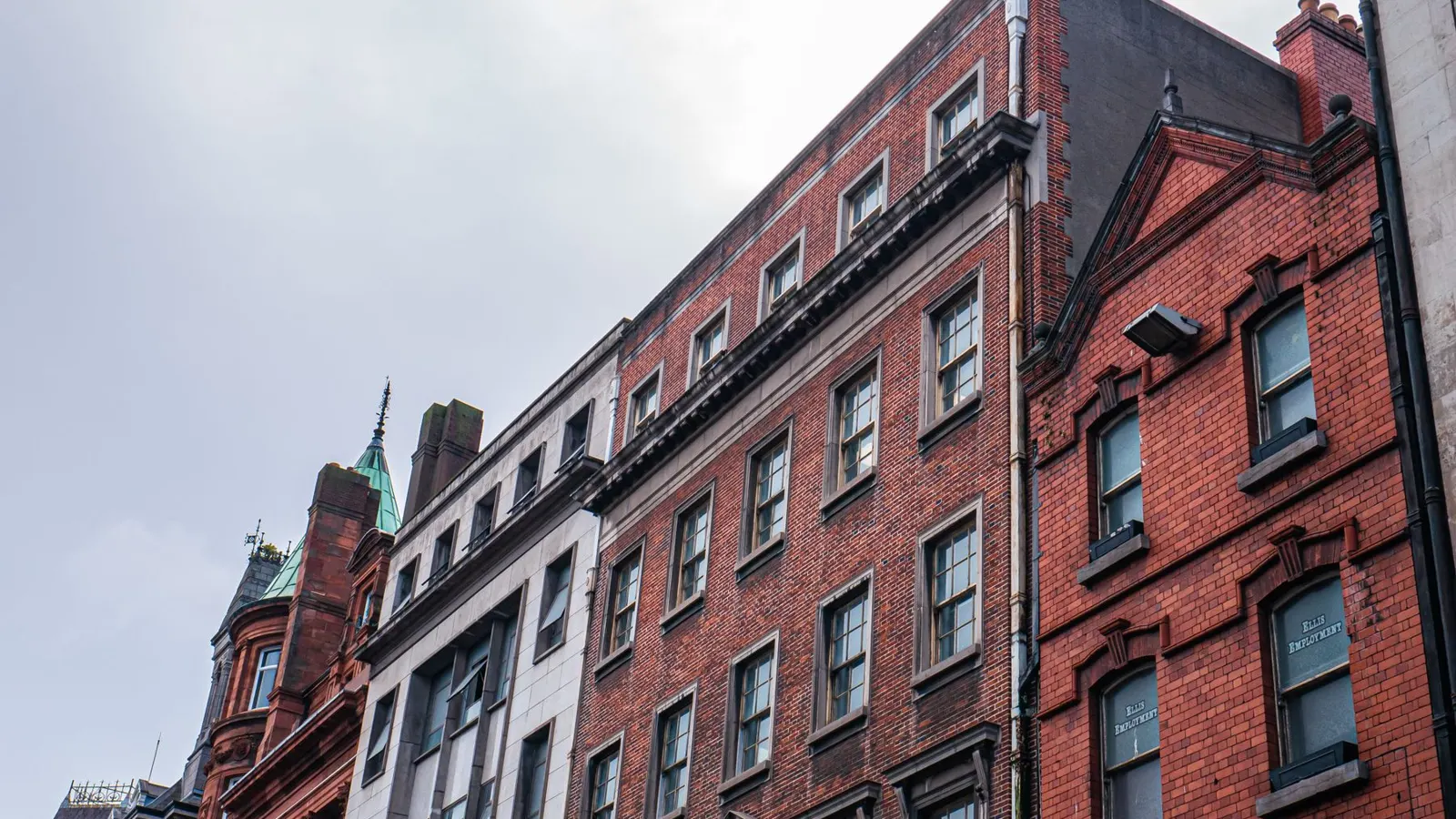 Red-brick Victorian buildings in central Dublin seen from the street