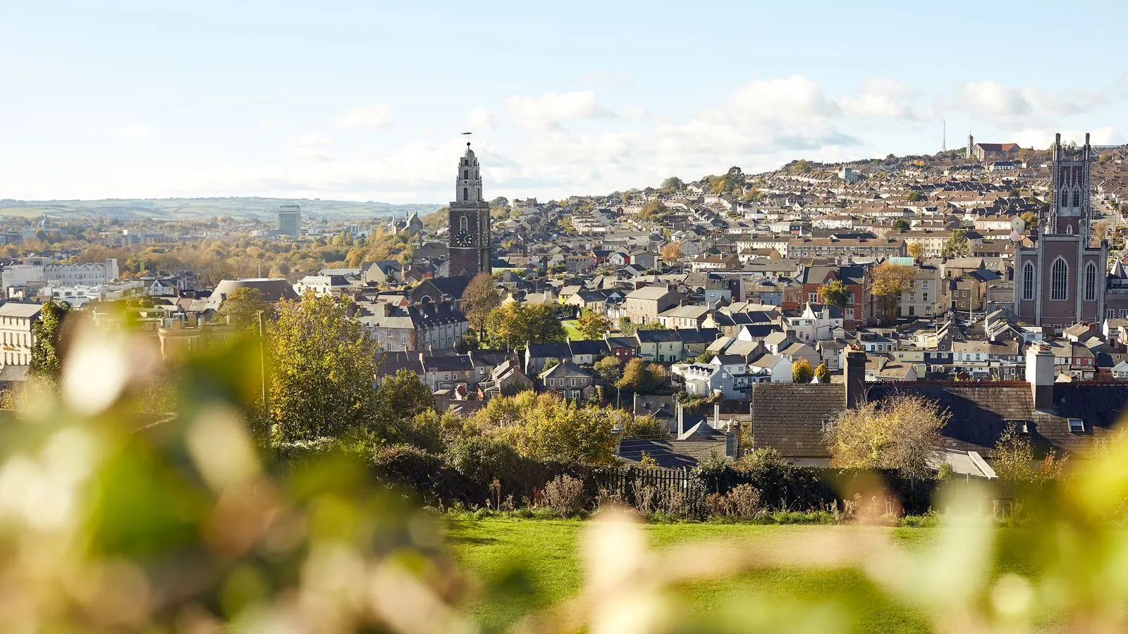 Cork city houses climbing the hill to Shandon bell tower on an autumn day